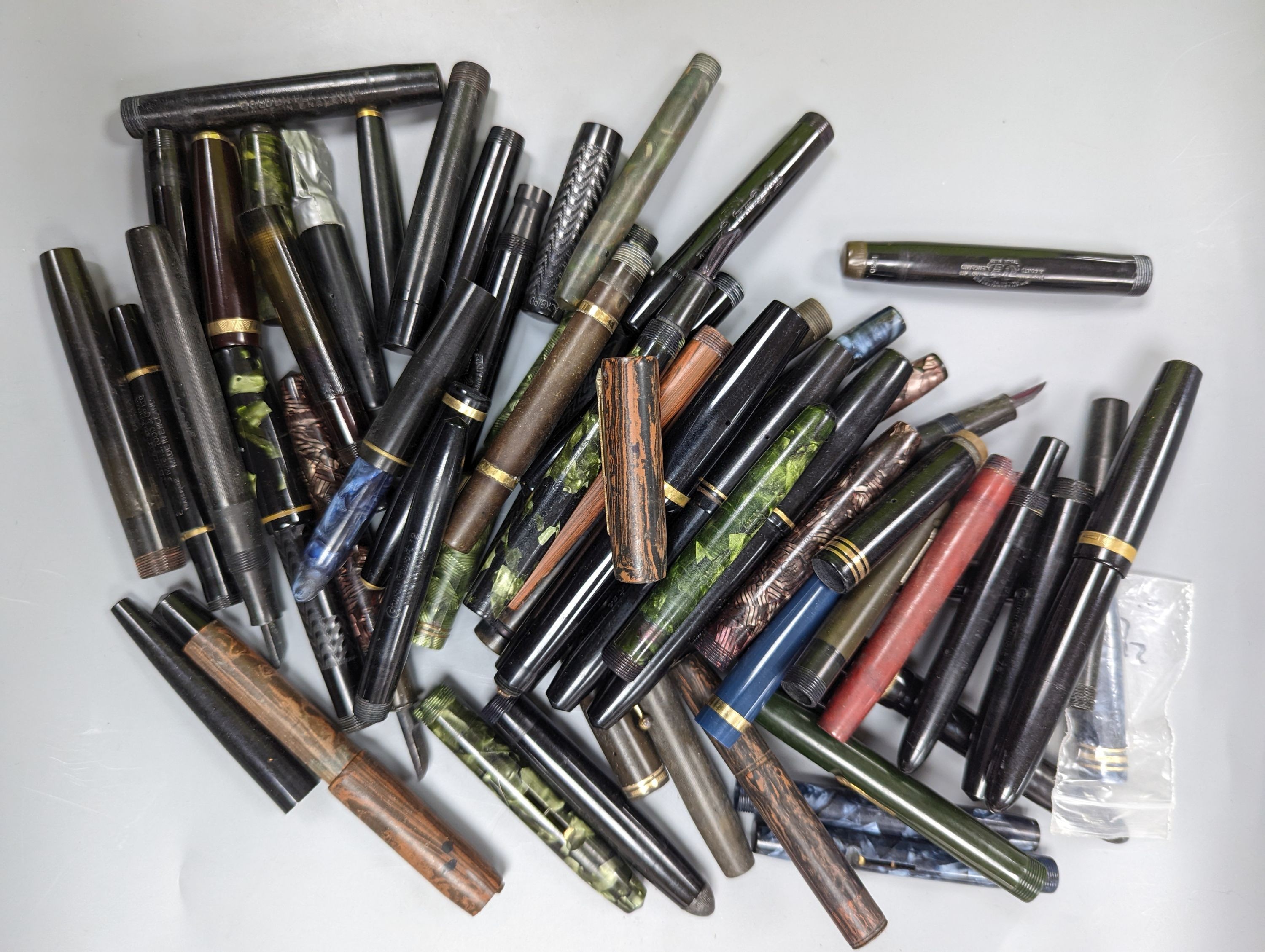 A quantity of fountains pens and pen parts